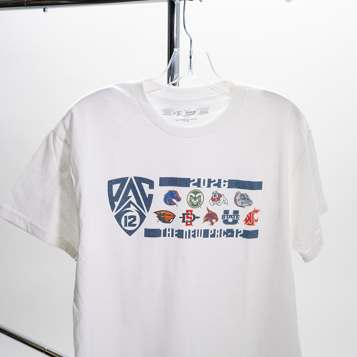 2026 pac-12 logo t-shirt closeup while shirt is hanging on clothing rack